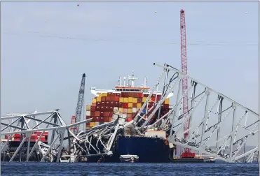  ?? JULIA NIKHINSON — THE ASSOCIATED PRESS ?? The collapsed Francis Scott Key Bridge rests on top of the container ship Dali on Monday in Baltimore. East Coast ports, railways, truckers and shipping lines have gone to enormous lengths to remake supply chains since the collapse.