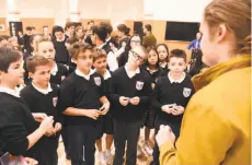  ?? Josh Edelson / Special to The Chronicle ?? Students crowd around “Science Fair” star Robbie Barrat (right) at Holy Name School in San Francisco.