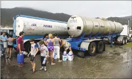  ?? CARLOS GIUSTI — THE ASSOCIATED PRESS ?? Locals arrive at a water collection point Thursday, a day after the impact of Hurricane Maria, in Yabucoa, Puerto Rico. As of Thursday evening, Maria was moving off the northern coast of the Dominican Republic with winds of 120mph.