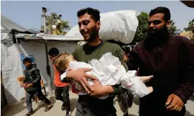  ?? Photograph: APAImages/Rex/ Shuttersto­ck ?? Relatives of a Yasmeen Abu Rkab, aged two, who died in Israeli attacks, receive her body from the morgue of Al-Aqsa hospital in Gaza on Wednesday.