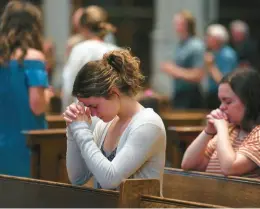  ?? JESSIE WARDARSKI/AP ?? Olivia Meholic prays Sunday at St. Paul Catholic Cathedral in Pittsburgh. During the service, the Very Rev. Kris Stubna gave a homily focused on the abortion decision.