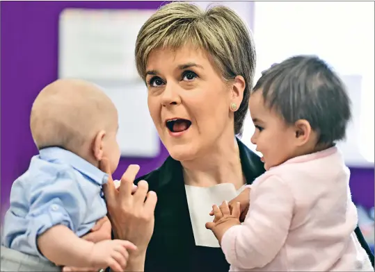  ??  ?? Nicola Sturgeon, seen spending time with Leo Donegan and Nina Fredrick on a visit to Glasgow in April, has vowed to improve kids’ lives