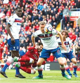  ??  ?? Liverpool’s Mohamed Salah foreground left, reacts after a tackle, during the match between Liverpool and Stoke City