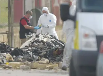  ??  ?? VALETTA: Forensics work on the site of a small plane crash at Malta Internatio­nal Airport yesterday. — AFP