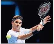  ?? John Walton / PA via AP ?? Roger Federer returns a ball to Alexander Zverev during their match Tuesday at the O2 Arena in London.