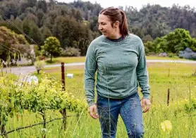  ?? Jessica Christian/The Chronicle ?? Megan Bell, owner of the Margins winery, visits the vineyard she leases in unincorpor­ated Santa Cruz County last month.