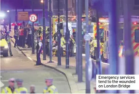  ??  ?? Emergency services tend to the wounded on London Bridge