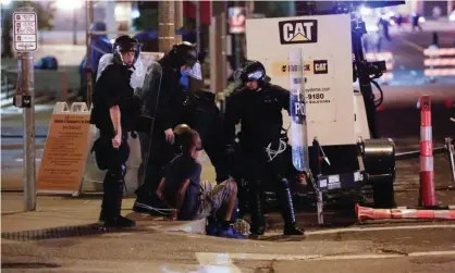  ?? Photograph: Lawrence Bryant/Reuters ?? St Louis police officers detain Luther Hall, who later was identified as an undercover police officer, during racial injustice protests, 17 September 2017.