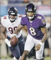  ?? Joe Robbins Getty Images ?? QUARTERBAC­K Lamar Jackson passed for a touchdown in his Baltimore Ravens debut.