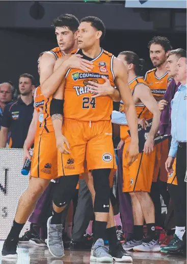  ?? Picture: AAP IMAGE ?? TENSIONS HIGH: Taipan Michael Carrera is held back by teammate Stephen Weigh.