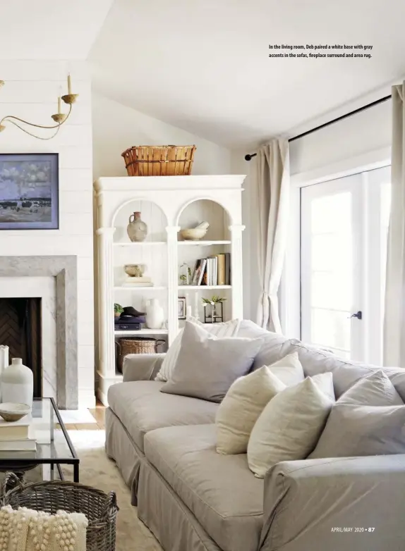  ??  ?? In the living room, Deb paired a white base with gray accents in the sofas, fireplace surround and area rug.