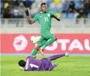  ??  ?? Scorer of Super Eagles goal against Libya, Sunday Faleye attempts to lob the ball over Rwanda goalkeeper in the match between Nigeria and Rwanda on January 15.