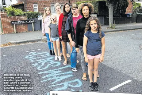  ??  ?? Residents in the road, showing where resurfacin­g ends at the spot where a wall with spikes stood, below, to separate council houses from wealthier families