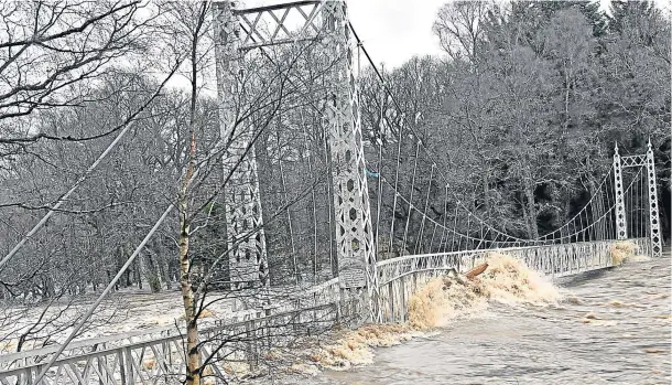  ?? Photograph by Colin Rennie ?? REVIVAL: The Cambus O’May suspension bridge, near Ballater, was severely damaged by the storm – but could be back in use by the summer.