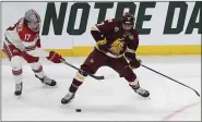  ?? STACY BENGS — THE ASSOCIATED PRESS ?? Minnesota Duluth’s Scott Perunovich (7) tries to maintain the puck against Ohio State’s Sam McCormick in 2018.