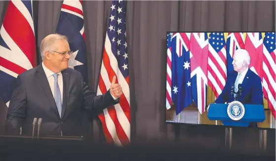  ??  ?? PM Scott Morrison gestures to US President Joe Biden during a video call in Canberra and (below) British PM Boris Johnson. Picture: Newswire