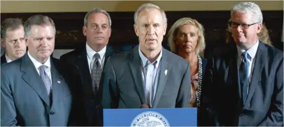  ??  ?? Gov. Bruce Rauner ( center) speaks at a news conference last month. House Republican Leader Jim Durkin ( far right) and Senate Republican Leader designee Bill Brady ( second from left) said in a statement Thursday that legislativ­e leaders had reached a...