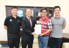  ??  ?? Tai presenting Edward (2nd left) with an invitation to the 4th UGKK Inter-Church Basketball Tournament.