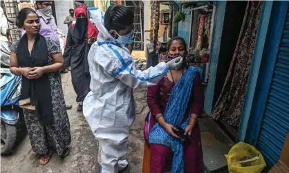  ??  ?? A health worker administer­s a Covid test in Mumbai, India. Photograph: Indranil Mukherjee/AFP/Getty Images