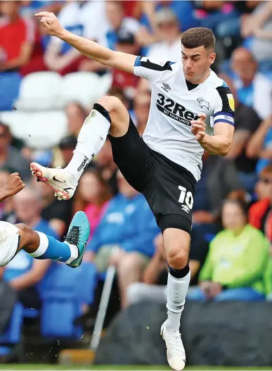  ??  ?? Tom Lawrence (right) pictured in action for Derby County against Peterborou­gh United this season.