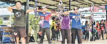  ??  ?? State archers (from left) Chio Chung Yin, Vanessa Voon, Kho Yee Ting and Ngu Gao Teck taking aim during a training session. — Photos by Teo Chi Wei