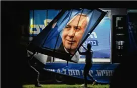  ?? AMIT ELKAYAM/NEW YORK TIME ?? People prepared for the arrival of Benjamin Netanyahu during a campaign stop in Be’er Sheva, Israel.