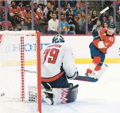  ?? BRUCE BENNETT/GETTY ?? The Panthers’ Gustav Forsling scores the game-winning goal in overtime against Capitals goaltender Charlie Lindgren on Saturday at Amerant Bank Arena in Sunrise. The Panthers defeated the Capitals 3-2 in overtime.