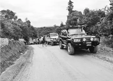  ??  ?? The 4WDs in a line as the drivers manoeuvre them along a muddy road.