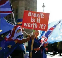  ?? - Reuters file photo ?? PROTEST: Anti-Brexit protesters wave flags outside the Houses of Parliament in London, Britain.