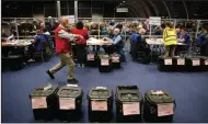 ?? (AP/Peter Morrison) ?? Election staff members begin vote counting for the Northern Ireland Assembly election early Friday in Belfast, Northern Ireland.