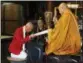  ?? KOJI UEDA — THE ASSOCIATED PRESS ?? In this Saturday photo, Kazuki Yazawa, left, canoe slalom Olympian and Buddhist priest, receives wooden tablets for good luck from Kansho Kayaki, deputy chief priest, at Zenkoji Daikanjin Temple in Nagano, Japan.