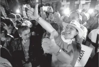  ?? JOHN VIZCAINO / REUTERS ?? Supporters of “No” vote celebrate after the nation voted “No” in a referendum on a peace deal between the government and Revolution­ary Armed Forces of Colombia, in Bogota, Colombia, on Sunday.