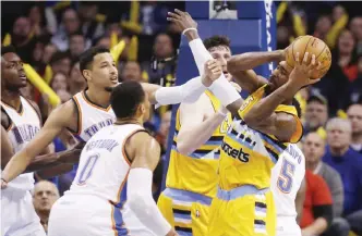  ??  ?? OKLAHOMA CITY: Denver Nuggets guard Will Barton (5) grabs a rebound in front of Oklahoma City Thunder forward Andre Roberson, left, and guard Russell Westbrook (0) in the fourth quarter of an NBA basketball game in Oklahoma City, Saturday. Oklahoma...