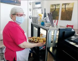  ?? SUBMITTED PHOTO ?? Louise Vernal, owner of Inspire Cafe, displays some freshly baked muffins. The extension of COVID-19 restrictio­ns this week was not entirely unexpected.