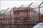  ?? BEBETO MATTHEWS - ASSOCIATED PRESS ?? In this 2011file photo, a security fence surrounds inmate housing on the Rikers Island correction­al facility in New York. New York City lawmakers are considerin­g a plan to close the notorious Rikers Island jail complex and replace it with four smaller jails.