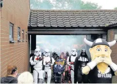  ??  ?? HFH U9 Reds and Ince Rose Bridge U9 are led out onto the pitch by Darth Vader and his Stormtroop­ers.