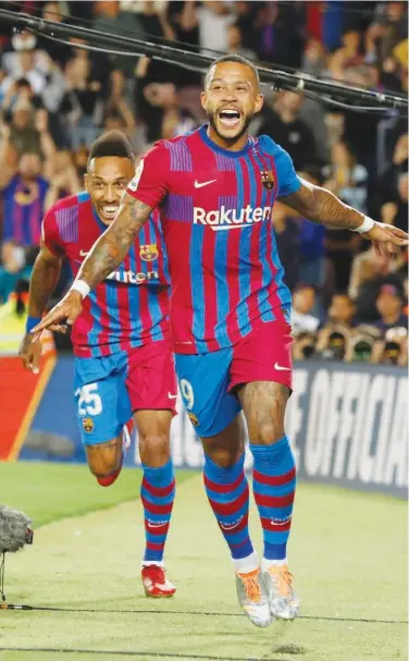  ?? Reuters ?? Barcelona’s Memphis Depay celebrates scoring the first goal with team-mate Pierre-emerick during their Spanish League match against Celta Vigo on Tuesday.