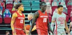  ?? COURTESY OF UNM ATHLETICS ?? Makuach Maluach of the Lobos (10) and teammate Javonte Johnson (13) were part of a strong first half for UNM on Monday night, but UNLV rallied for a 53-46 victory in the Mountain West.