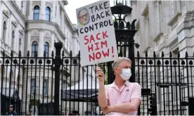  ?? Photograph: James Veysey/Rex/Shuttersto­ck ?? ‘Take back control. Sack him now!’ is the message from one protester outside Downing Street on 27 May 2020.