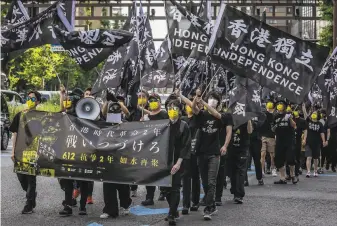  ?? Yuichi Yamazaki / Getty Images ?? Activists march in Tokyo in a demonstrat­ion of solidarity with prodemocra­cy advocates in Hong Kong. China has mounted a crackdown on dissent in the former British colony.