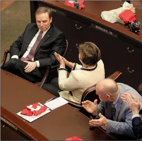  ?? Arkansas Democrat-Gazette/STATON BREIDENTHA­L ?? Members of the Arkansas House of Representa­tives, including Rep. Charlene Fite (center), R-Van Buren, and Rep. Mark McElroy (right), D-Tillar, applaud Monday afternoon for Rep. Matthew Shepherd (left), R-El Dorado, after he won the election to be the...