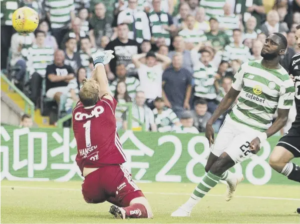  ?? PICTURE: JEFF HOLMES/PA ?? 0 Odsonne Edouard scores his second – and Celtic’s third – with an impudent chip over Rosenborg goalkeeper Andre Hansen.