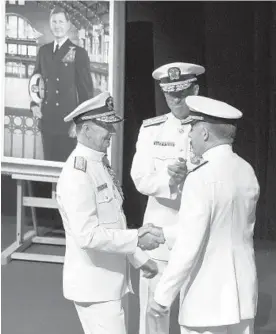  ?? PAUL W. GILLESPIE/ CAPITAL GAZETTE ?? From left, Naval Academy Superinten­dent Vice Adm. Ted Carter, Chief of Naval Operations Admiral John M. Richardson and incoming Superinten­dent Vice Adm. Sean Buck exchange handshakes after the change of command. Naval Academy Superinten­dent Vice Adm. Ted Carter handed off leadership of the service academy to new Superinten­dent Vice Adm. Sean Buck on Friday morning during a Change of Command Ceremony.