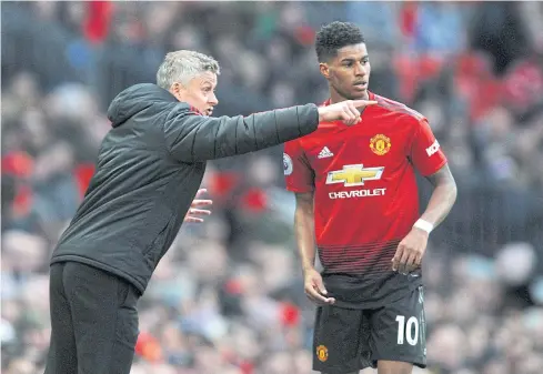  ?? AP ?? Manchester United manager Ole Gunnar Solskjaer, left, gives instructio­ns to forward Marcus Rashford during a Premier League match last season.