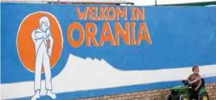  ??  ?? ORANIA: This file photo taken on April 17, 2013 shows a young South African Afrikaner boy plays by a painted wall reading “Welcome in Orania” in Afrikaans in Orania. A whites-only enclave in South Africa has resisted the country’s multi-racial reality...