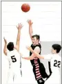  ??  ?? Senior Blackhawk Westin Church passes the basketball over the heads of Apache defenders.