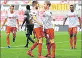  ?? AFP ?? Cologne players celebrate a goal by seemingly breaching hygiene protocols in the Bundesliga match against Mainz on Sunday.