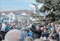  ?? ANDREW VAUGHAN THE CANADIAN PRESS ?? Doves are released at the funeral for Rebecca Schofield at Immaculate Heart of Mary Catholic Church in Riverview, N.B. on Wednesday.