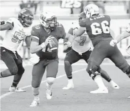  ?? JOHN RAOUX/AP ?? UCF senior offensive lineman Aaron Evans (66) has poured in a lot of work to protect quarterbac­k McKenzie Milton, left.