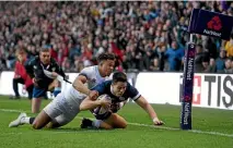  ?? PHOTO: GETTY IMAGES ?? New Zealand-born Scotland wing Sean Maitland scores during his side’s comprehens­ive win over England.